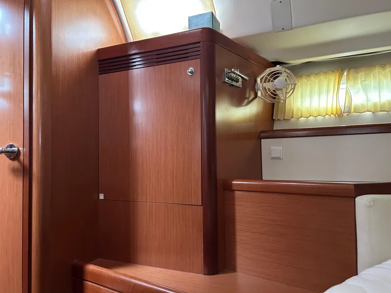 Slide: The Image of Interior of 2008 Beneteau Oceanis 46 yacht with wooden cabinetry and soft lighting. - 37