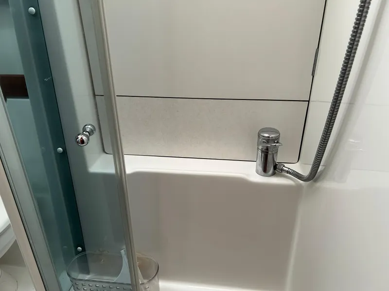 Slide: The Image of Shower area in 2008 Beneteau Oceanis 46 yacht, featuring modern fixtures and glass door. - 39