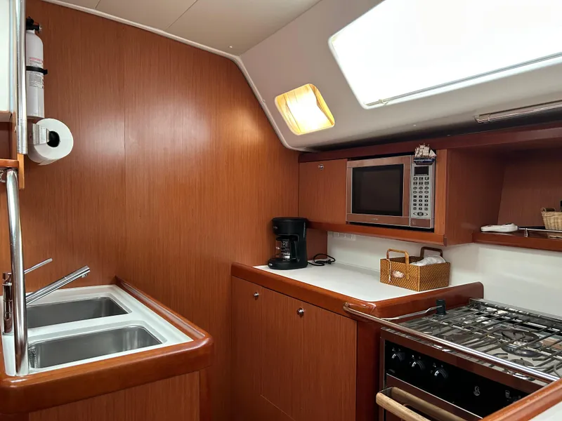 Slide: The Image of Galley kitchen in 2008 Beneteau Oceanis 46 yacht with wood finish and modern appliances. - 43