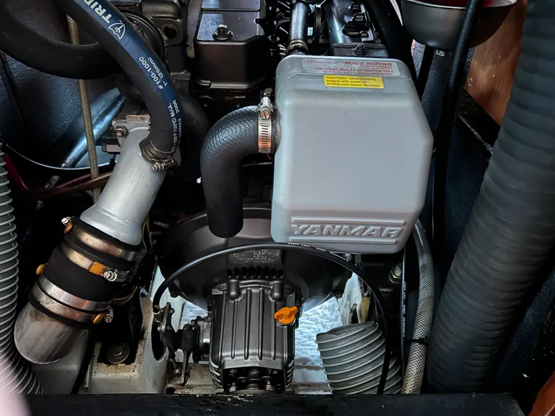 Slide: The Image of Engine compartment of a 2008 Beneteau Oceanis 46 sailboat, featuring a Yanmar engine. - 49