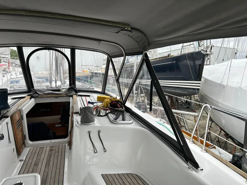 Slide: The Image of Beneteau Oceanis 46 sailboat cockpit, 2008 model, with covered seating and marina view. - 7