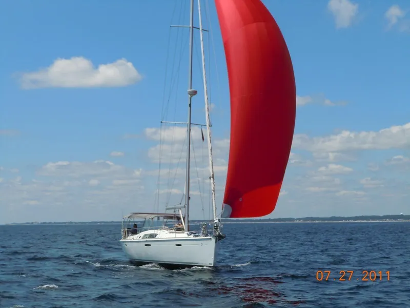 Slide: The Image of Beneteau Oceanis 46 sailboat with red spinnaker on open water, 2008 model. - 9