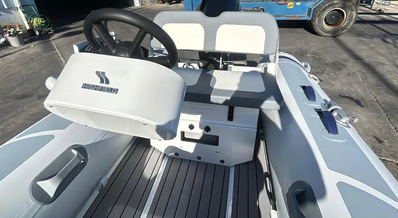 Slide: The Image of 2025 Highfield CL340 inflatable boat interior with steering wheel and seating. - 1