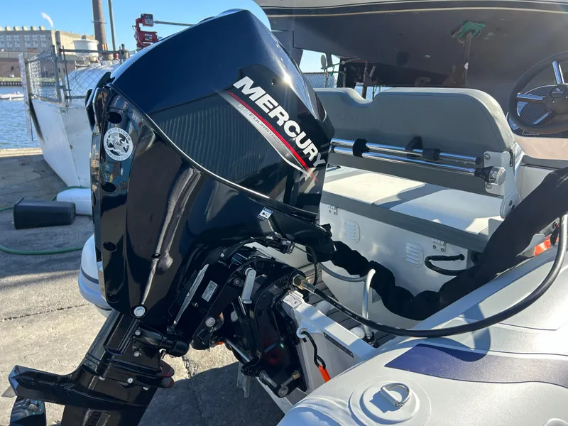 Slide: The Image of 2025 Highfield CL340 boat with Mercury outboard motor, docked by the water. - 8