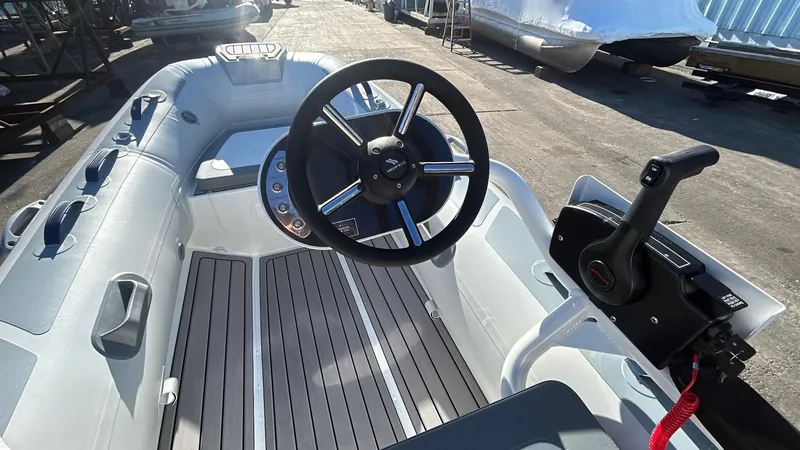 Slide: The Image of 2025 Highfield CL340 boat interior with steering wheel and control panel. - 2