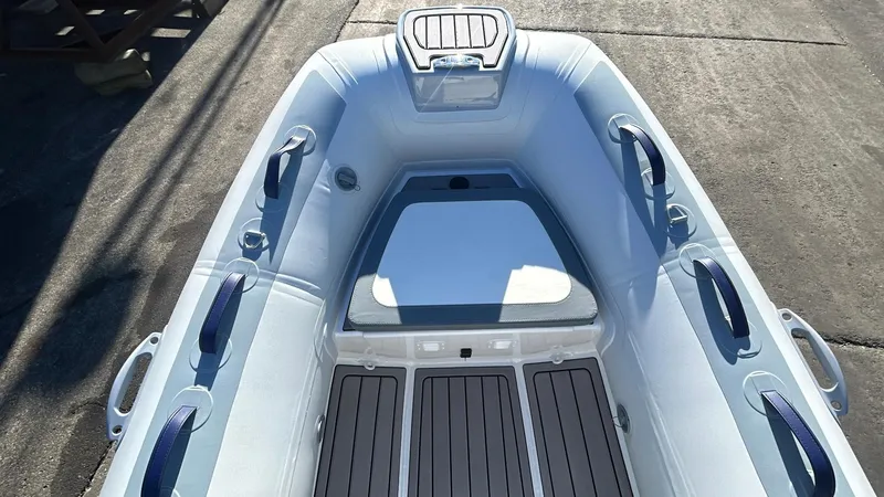 Slide: The Image of 2025 Highfield CL340 inflatable boat interior with seating and handles. - 5