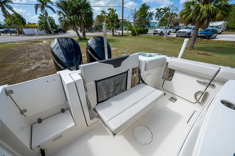 Slide: The Image of 2022 Sailfish 272CC boat interior with foldable seating and dual outboard motors. - 13