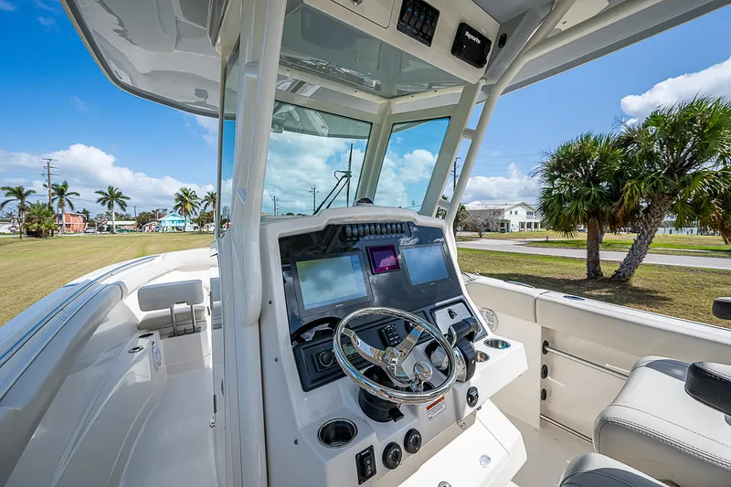 Slide: The Image of 2022 Sailfish 272CC boat cockpit with modern controls and steering wheel. - 17