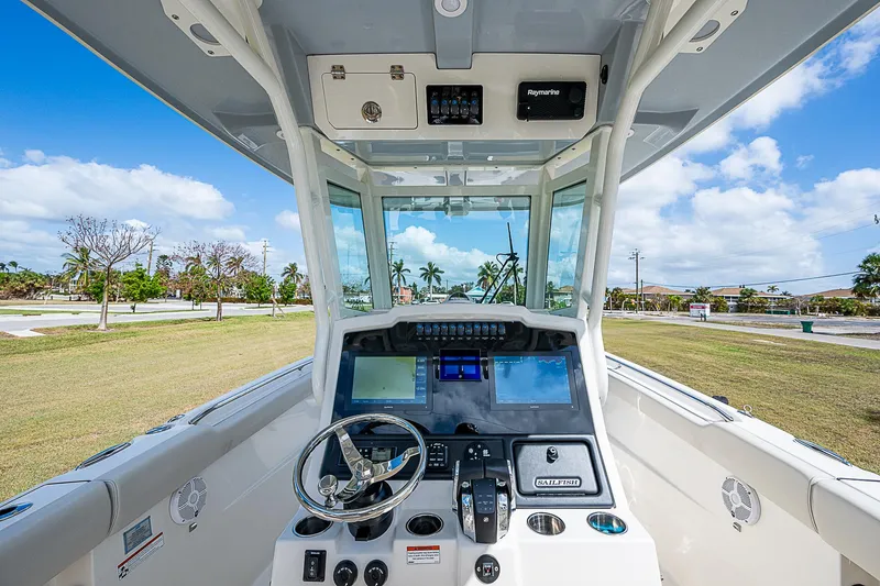Slide: The Image of 2022 Sailfish 272CC boat cockpit with modern navigation system and steering wheel. - 18