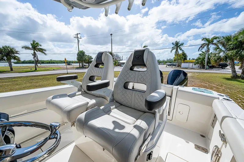 Slide: The Image of 2022 Sailfish 272CC boat interior with luxurious seating and steering wheel. - 21