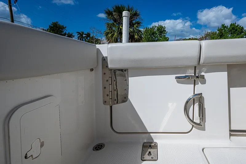 Slide: The Image of 2022 Sailfish 272CC boat interior with seating and hardware, under a clear blue sky. - 22