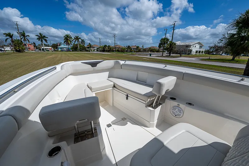 Slide: The Image of 2022 Sailfish 272CC boat interior with seating, under a blue sky. - 27