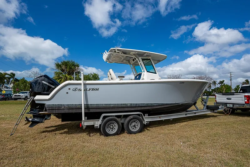 Slide: The Image of 2022 Sailfish 272CC boat on trailer under blue sky. - 3