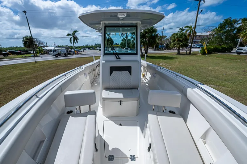 Slide: The Image of 2022 Sailfish 272CC boat interior with seating, under a blue sky. - 31