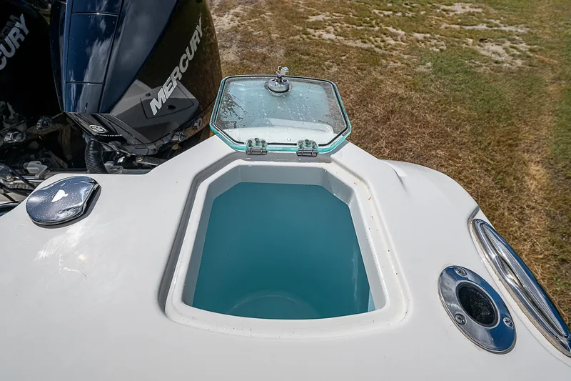 Slide: The Image of Sailfish 272CC 2022 boat livewell with open lid, Mercury engine visible. - 37