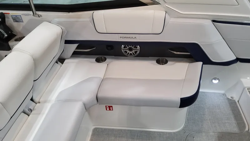Slide: The Image of 2025 Formula 330 Crossover Bowrider I/O interior seating with cup holders and speaker. - 16