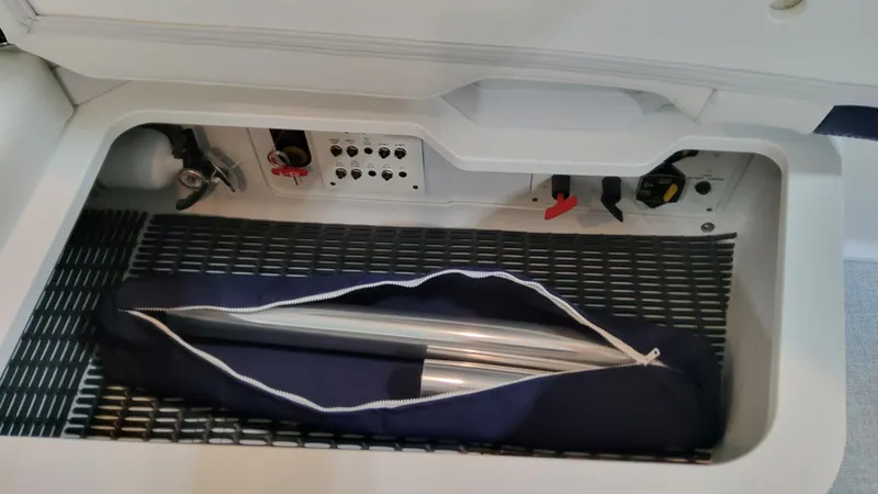 Slide: The Image of Storage compartment in 2025 Formula 330 Crossover Bowrider I/O with equipment bag. - 17