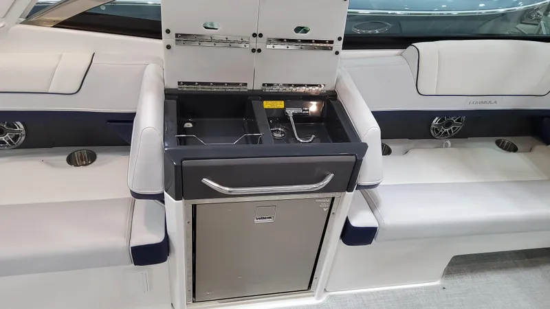 Slide: The Image of 2025 Formula 330 Crossover Bowrider I/O interior with sleek seating and built-in kitchenette. - 19