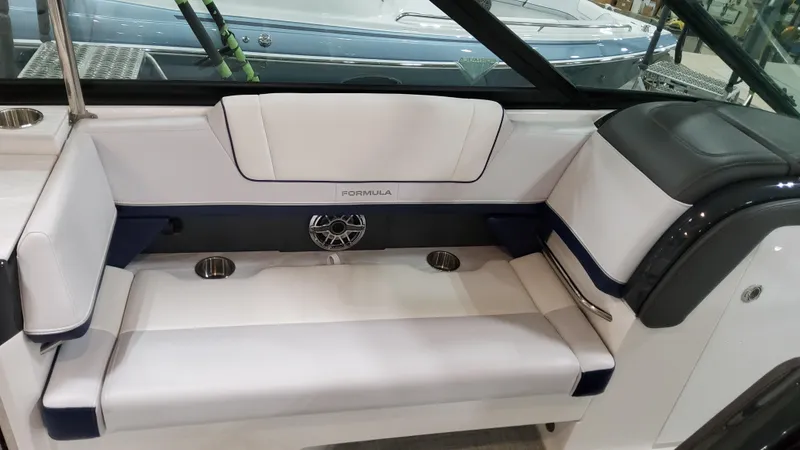 Slide: The Image of 2025 Formula 330 Crossover Bowrider I/O interior seating with cup holders and speaker. - 20