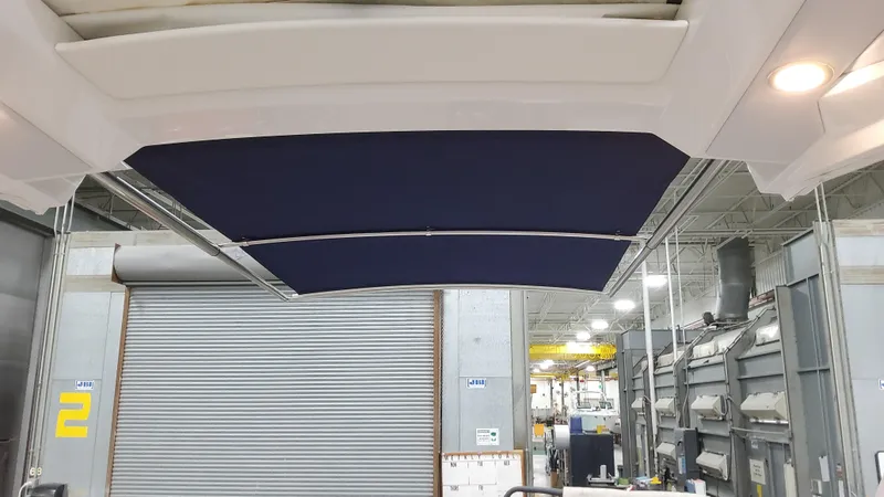 Slide: The Image of 2025 Formula 330 Crossover Bowrider I/O boat interior with retractable sunshade. - 26