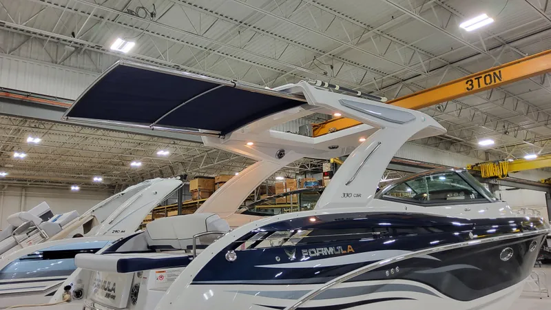 Slide: The Image of 2025 Formula 330 Crossover Bowrider I/O in showroom, featuring sleek design and modern amenities. - 27