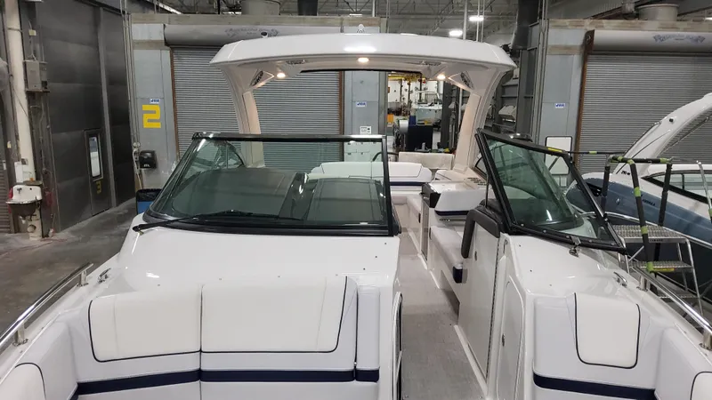 Slide: The Image of 2025 Formula 330 Crossover Bowrider I/O in a showroom, showcasing sleek design and spacious seating. - 35