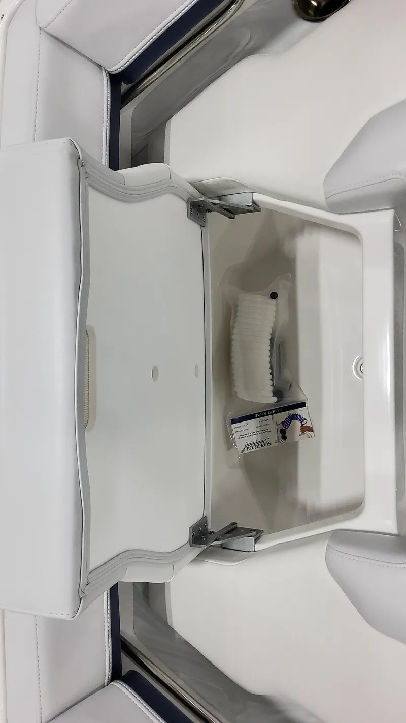 Slide: The Image of 2025 Formula 330 Crossover Bowrider I/O storage compartment with white cushioned seating. - 37