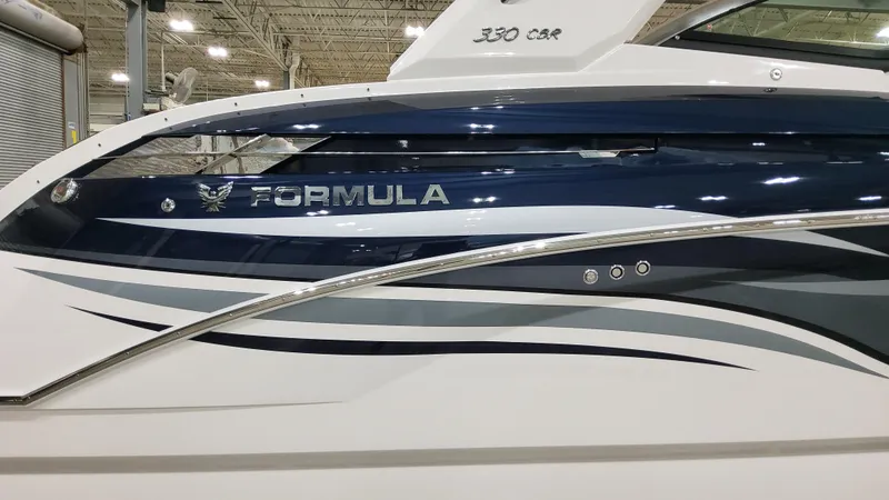 Slide: The Image of 2025 Formula 330 Crossover Bowrider I/O boat with sleek design and modern detailing. - 4