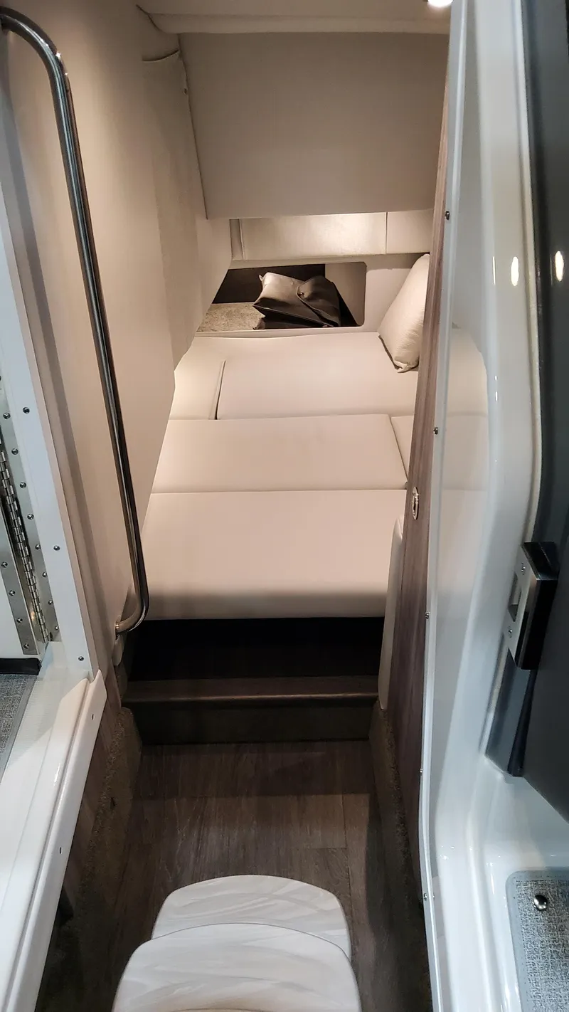 Slide: The Image of Interior cabin of 2025 Formula 330 Crossover Bowrider I/O, featuring sleek white seating. - 42