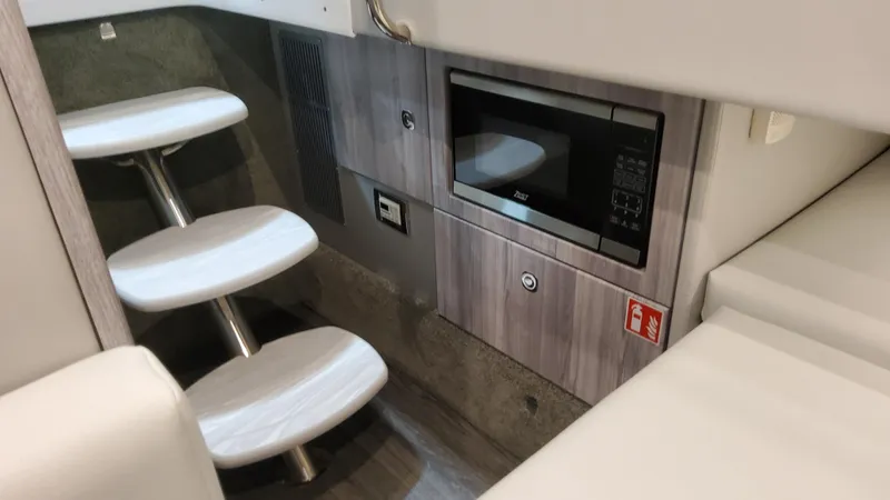 Slide: The Image of Interior of 2025 Formula 330 Crossover Bowrider I/O with microwave and modern stairs. - 48