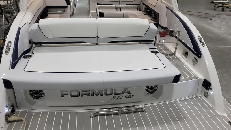 Slide: The Image of 2025 Formula 330 Crossover Bowrider I/O, luxury boat interior with sleek seating. - 7