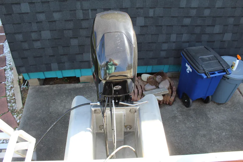 Slide: The Image of 2021 Sun Tracker Bass Buggy 16 XL Select outboard motor, parked on concrete driveway. - 18
