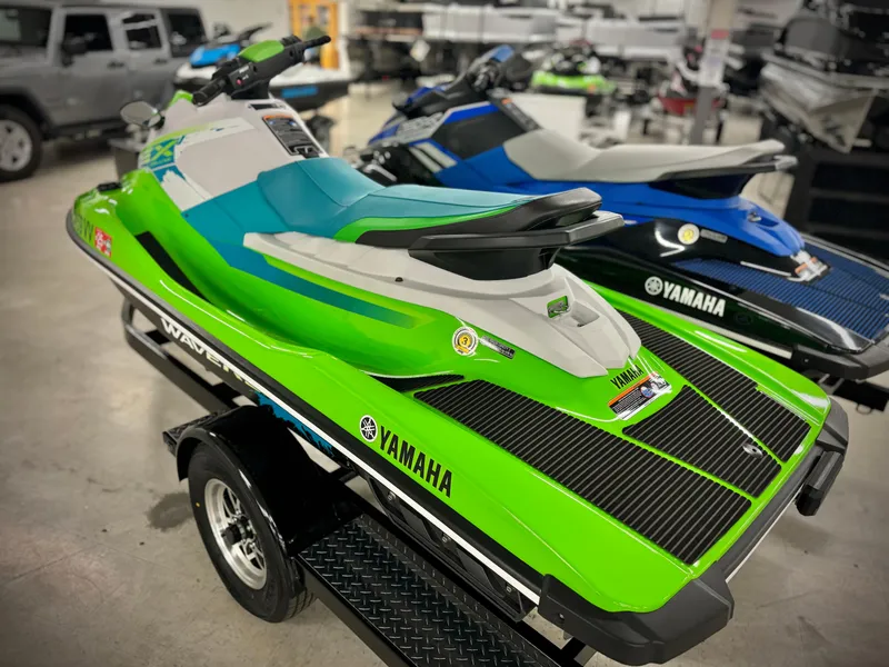 Slide: The Image of 2022 Yamaha WaveRunner EX in vibrant green on display in showroom. - 3