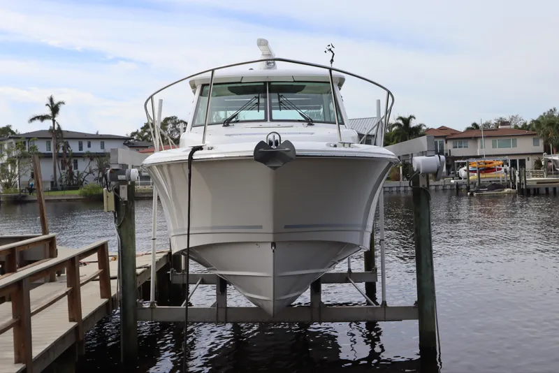 Slide: The Image of 2019 Boston Whaler 315 Conquest boat docked at marina, front view. - 1