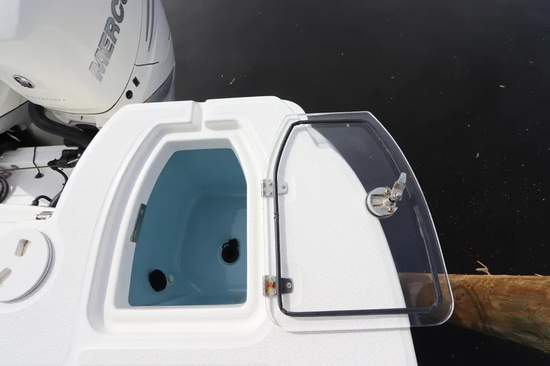 Slide: The Image of Boston Whaler 315 Conquest 2019 boat with open livewell and Mercury engine. - 10