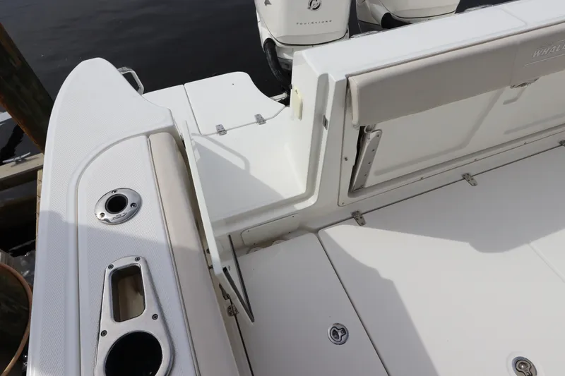 Slide: The Image of 2019 Boston Whaler 315 Conquest boat deck with seating and storage compartments. - 11