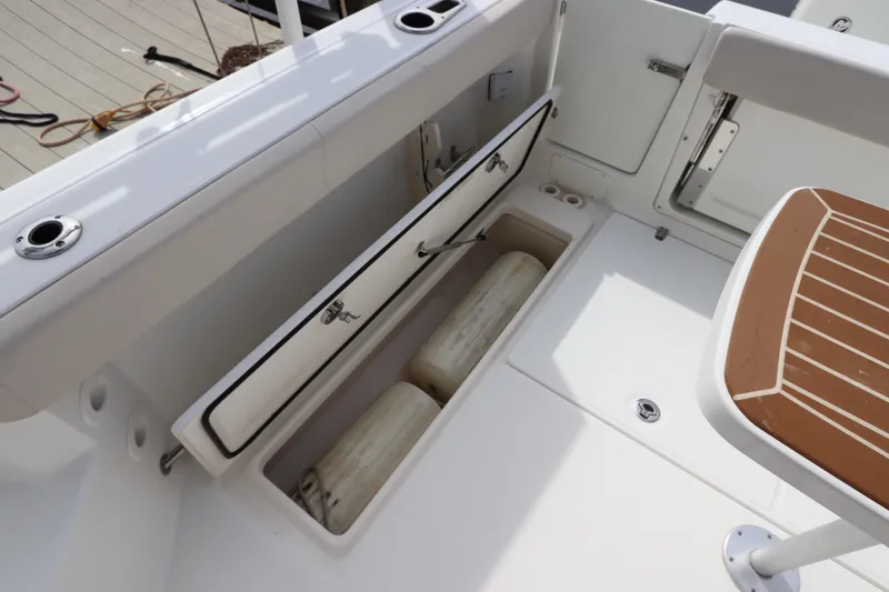 Slide: The Image of Boston Whaler 315 Conquest 2019 boat storage compartment with fenders. - 18
