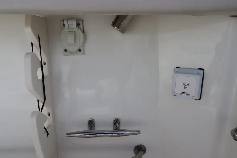 Slide: The Image of 2019 Boston Whaler 315 Conquest boat interior with utility outlets and fixtures. - 19