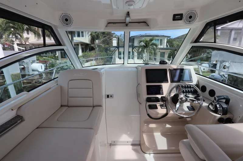 Slide: The Image of Interior of 2019 Boston Whaler 315 Conquest boat with modern helm and seating. - 22