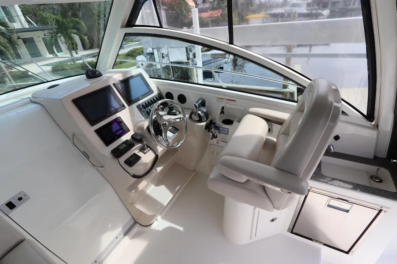 Slide: The Image of 2019 Boston Whaler 315 Conquest helm with modern controls and comfortable seating. - 25