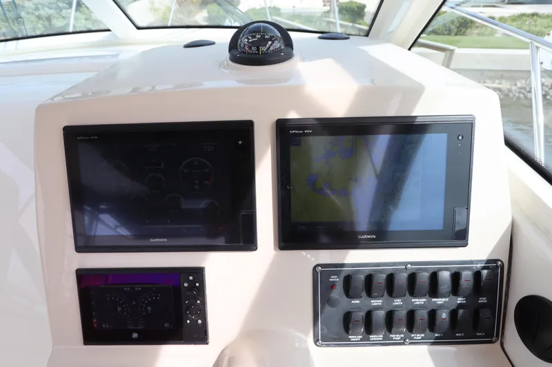 Slide: The Image of 2019 Boston Whaler 315 Conquest helm with navigation screens and controls. - 30