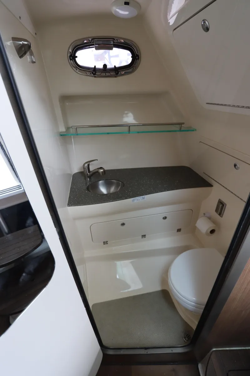 Slide: The Image of 2019 Boston Whaler 315 Conquest boat bathroom with sink, toilet, and storage. - 39