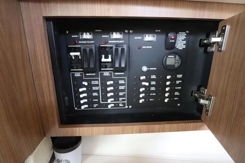 Slide: The Image of Electrical panel inside 2019 Boston Whaler 315 Conquest boat, featuring switches and controls. - 42