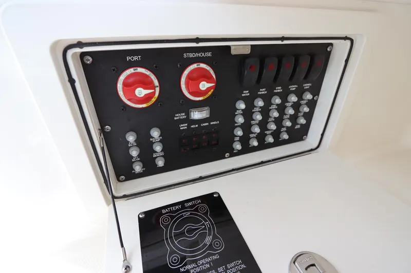 Slide: The Image of Control panel of a 2019 Boston Whaler 315 Conquest boat, featuring switches and dials. - 43
