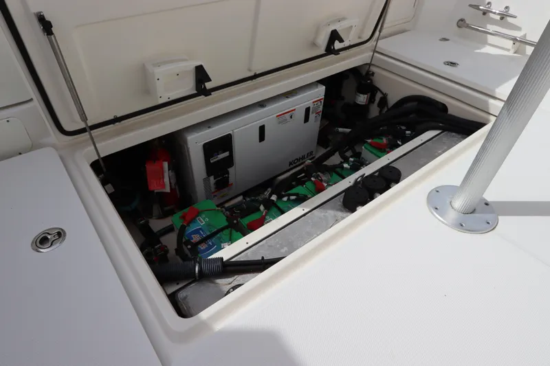 Slide: The Image of 2019 Boston Whaler 315 Conquest engine compartment with generator and wiring. - 44