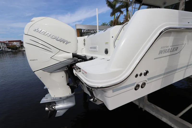 Slide: The Image of 2019 Boston Whaler 315 Conquest with Mercury outboard engine on water. - 8