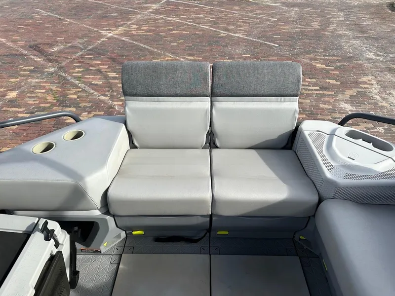 Slide: The Image of 2023 Sea-Doo Switch Cruise 21 interior seating with cup holders and gray upholstery. - 12