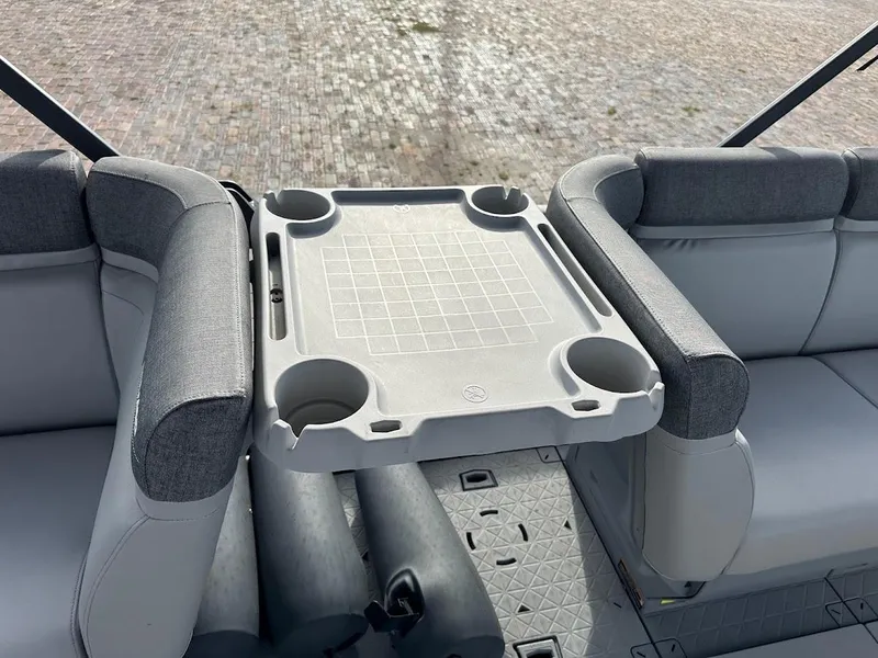 Slide: The Image of 2023 Sea-Doo Switch Cruise 21 interior with seating and table, featuring cup holders. - 15