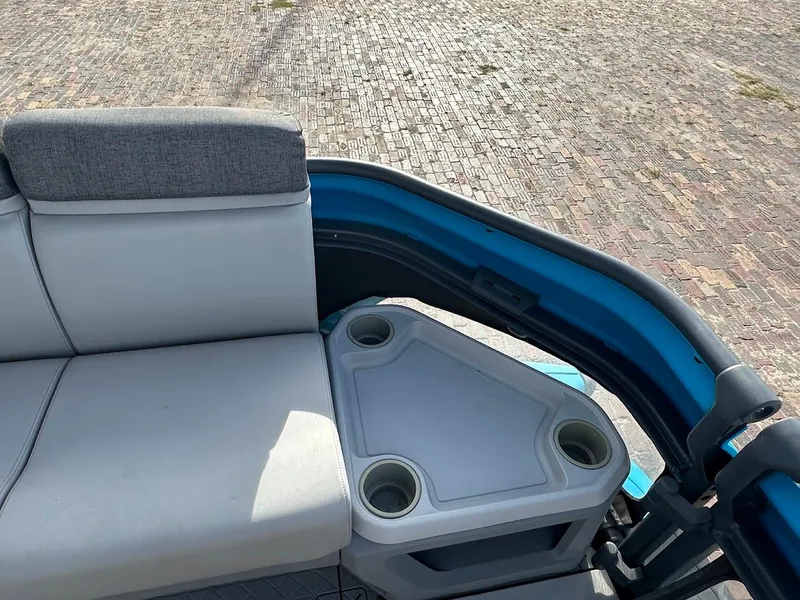Slide: The Image of 2023 Sea-Doo Switch Cruise 21 interior with seating and cup holders. - 17