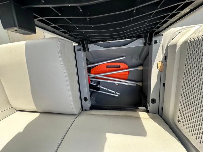 Slide: The Image of Storage compartment in 2023 Sea-Doo Switch Cruise 21 with safety equipment and accessories. - 23